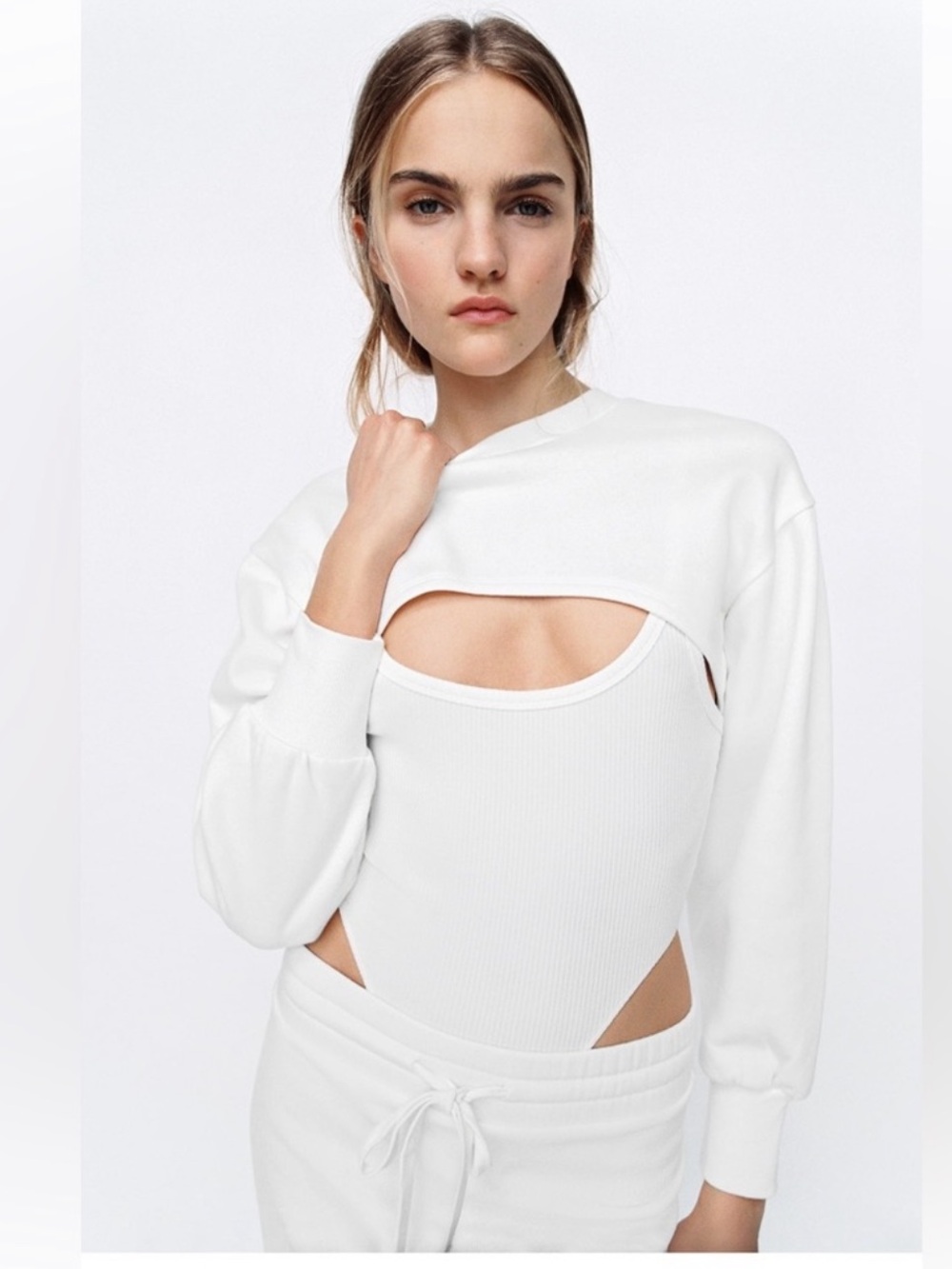 Zara shrug features long sleeves and a crew neck.